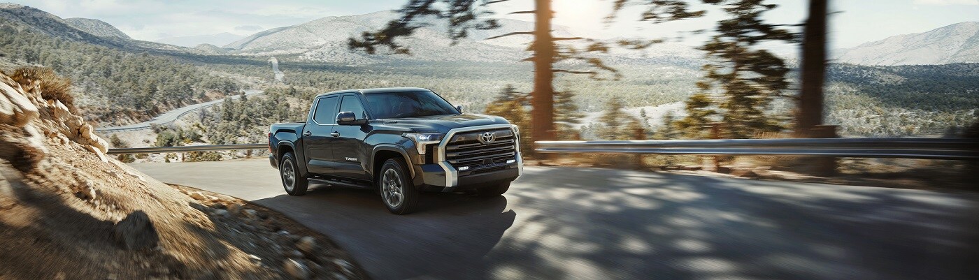 Toyota Tundra Black Toyota Tundra driving on a road up a hill
