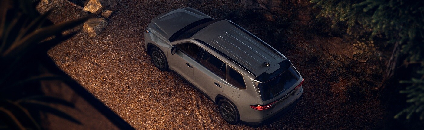 Toyota Grand Highlander Hybrid Grey Toyota Grand Highlander Hybrid Limited Nightshade parked in the forest