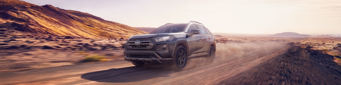 Grey Toyota RAV4 TRD Off Road with a bike rack parked in the desert