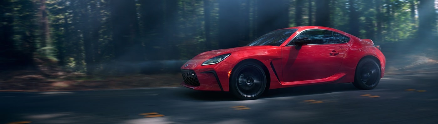 Toyota GR86 Red Toyota GR86 Bases driving on a forest road