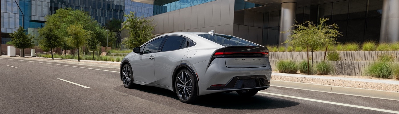 Silver Toyota Prius XLE driving in a sunny city