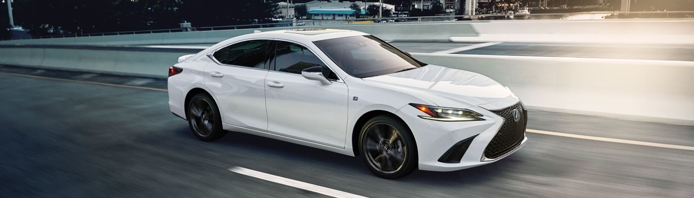 White Lexus ES sedan driving over a bridge