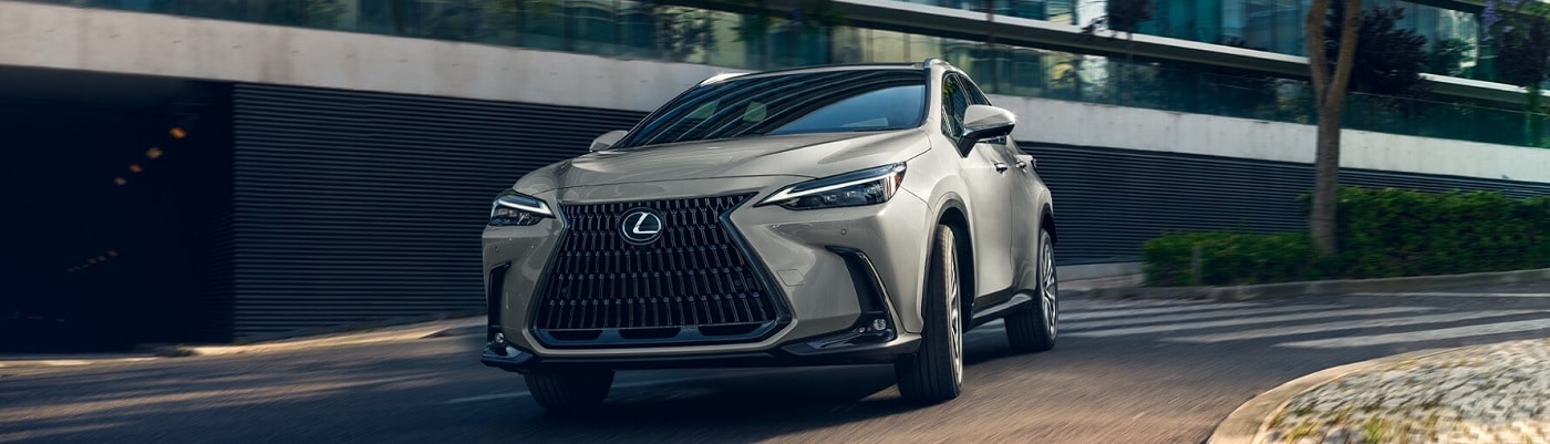 Beige Lexus NX driving near an office