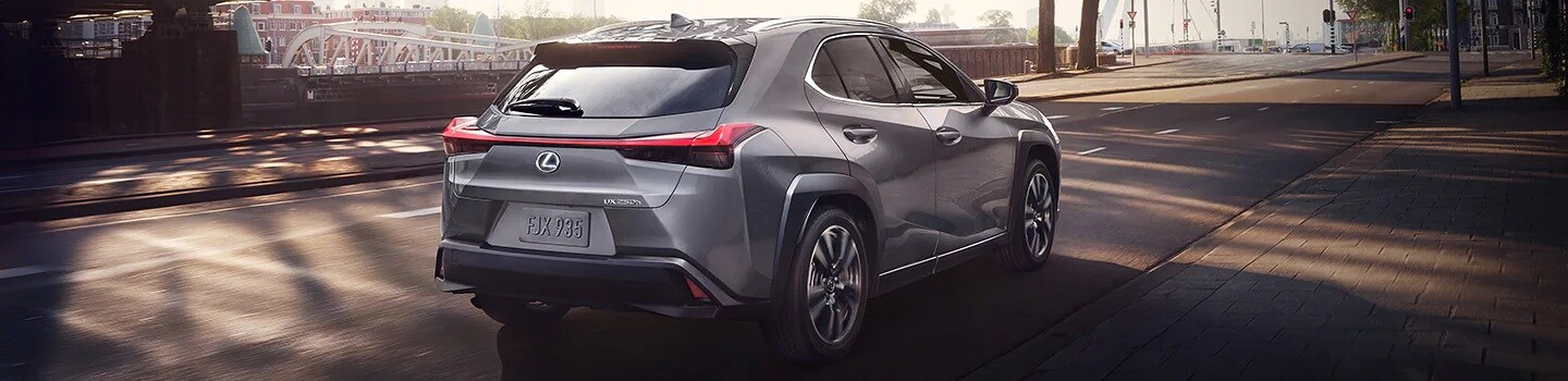Grey Lexus UX driving away in a city