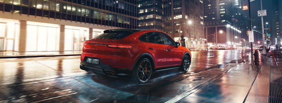 Cayenne Coupe driving on a rainy city street