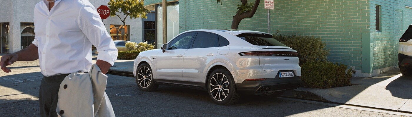 White Cayenne Coupe E-Hybrid parked on a city street in Miami