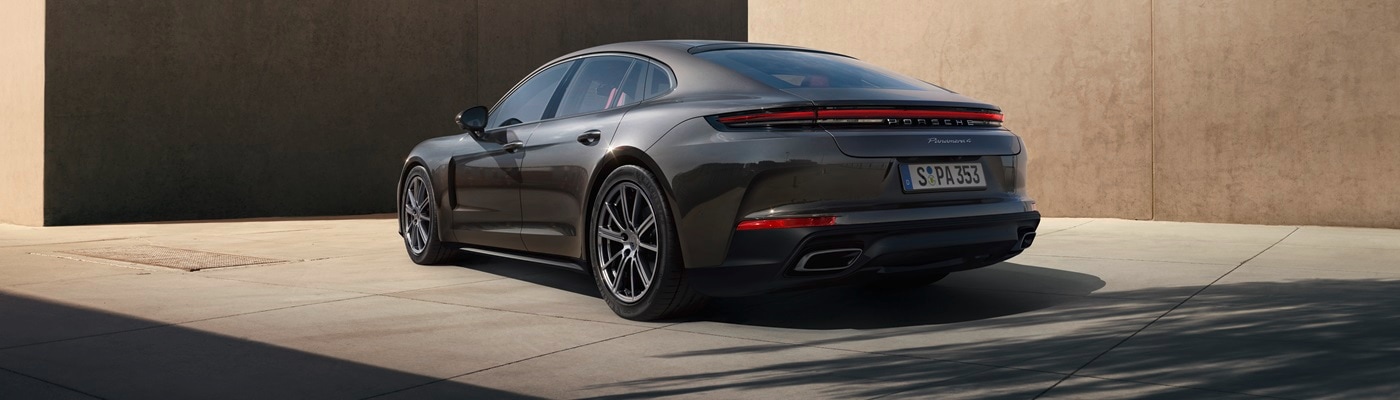 Grey Panamera 4S parked near a modern building