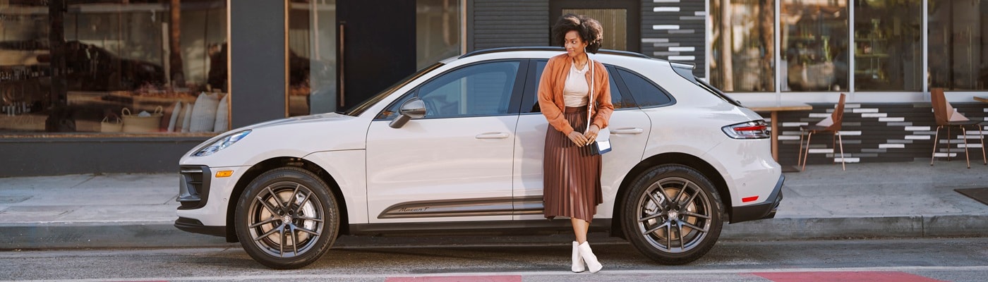 White Porsche Macan T parked on a city street
