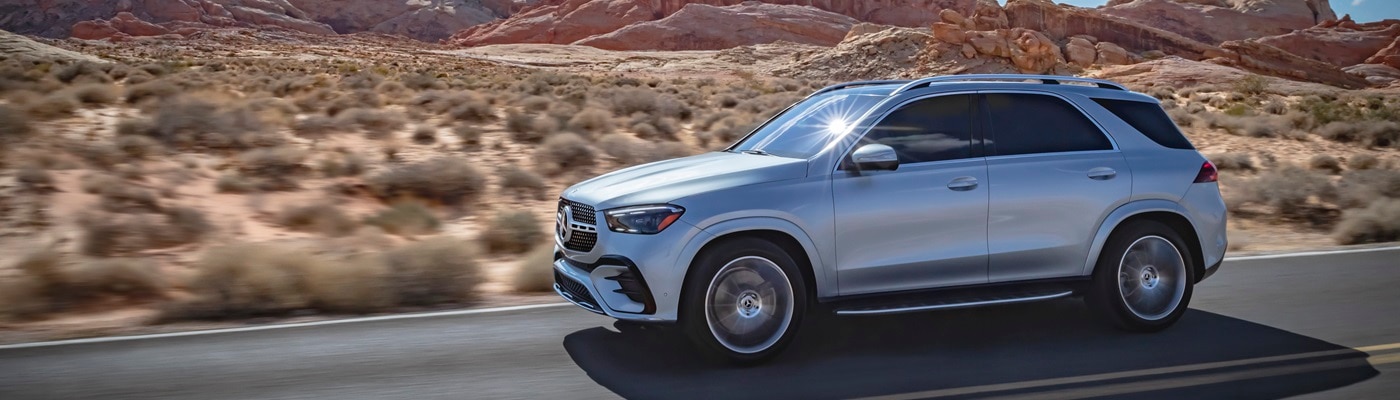 Silver Mercedes-Benz GLE 450 driving on a road in the desert