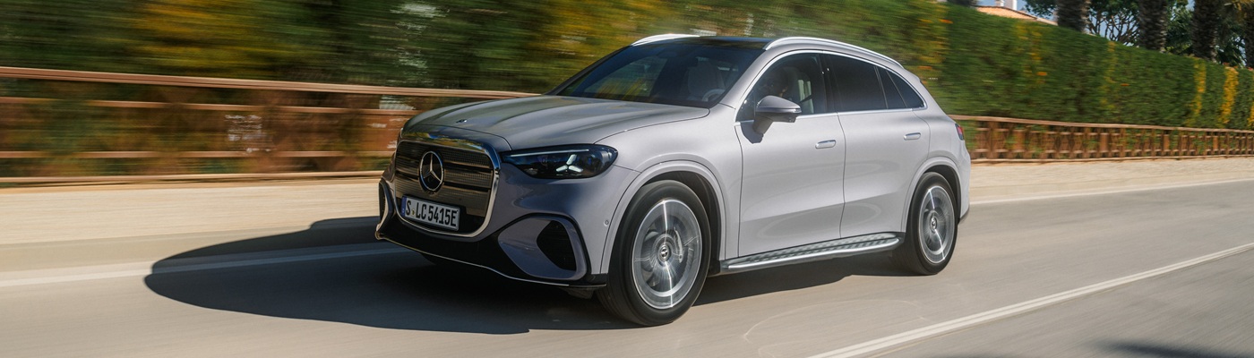 Grey Mercedes-Benz GLC EV SUV driving on a sunny road