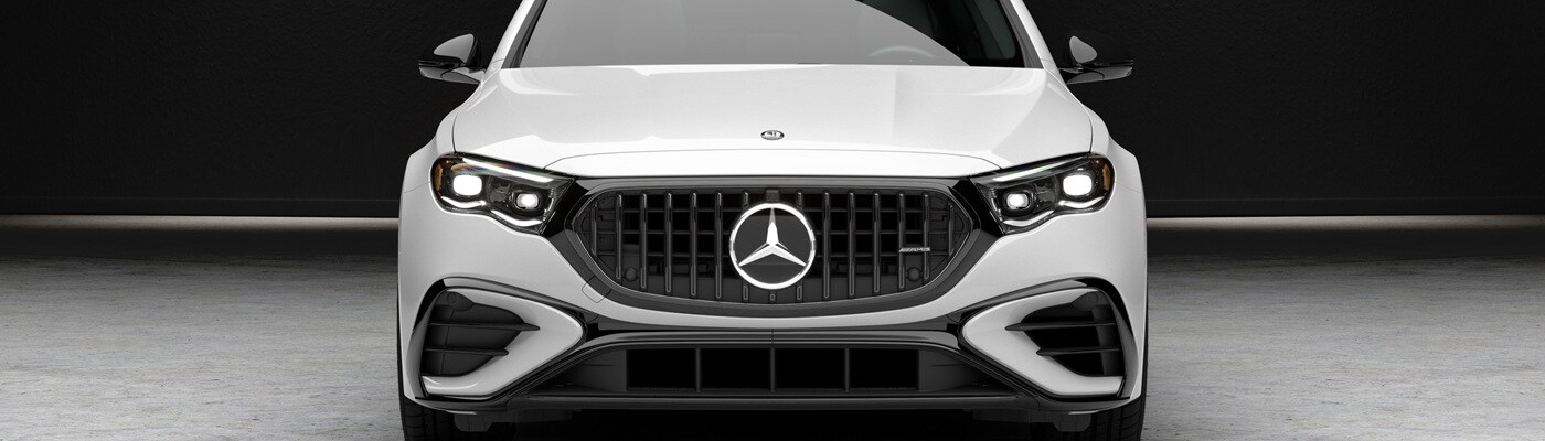 White Mercedes-Benz AMG E-Class sedan parked in a warehouse