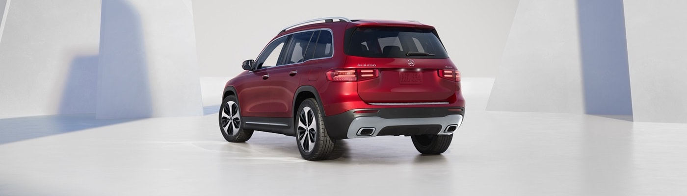 Mercedes-Benz GLB Red Mercedes-Benz GLB parked by white geometric shapes