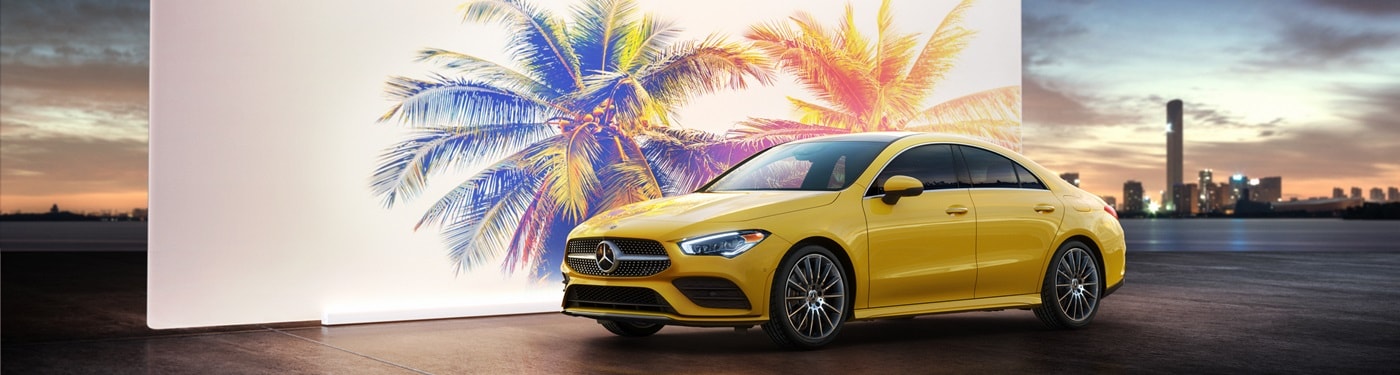 Mercedes-Benz CLA A Yellow Mercedes-Benz CLA parked by a city harbor