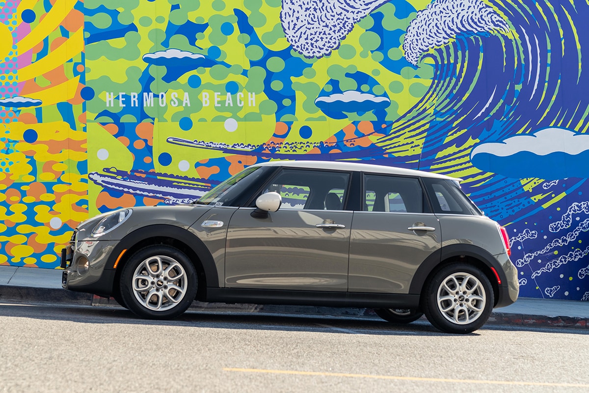 McKenna Kosmetics at South Bay MINI 2020 MINI Cooper Hardtop 4 Door parked next to a colorful mural in Hermosa Beach.