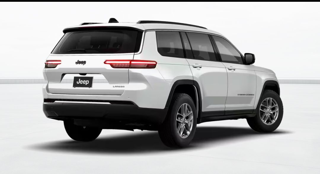 White Jeep Grand Cherokee L shown from a rear three-quarter view.