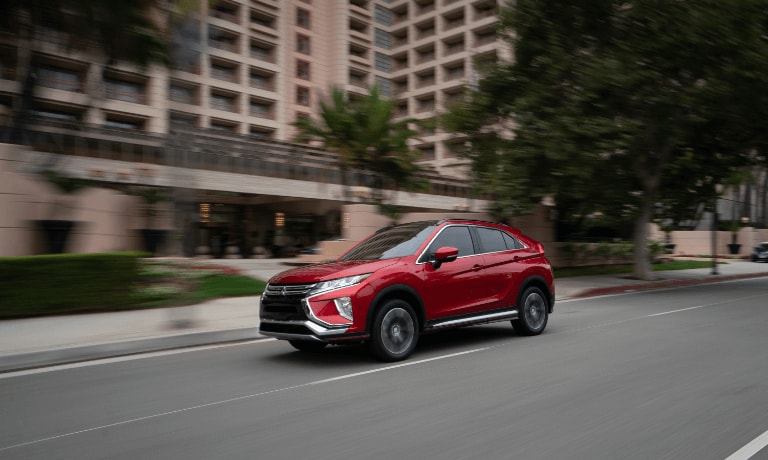 Red 2019 Mitsubishi Eclipse Cross driving on street