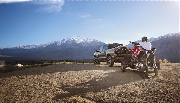 Nissan Titan in the mountains with dirt bikes