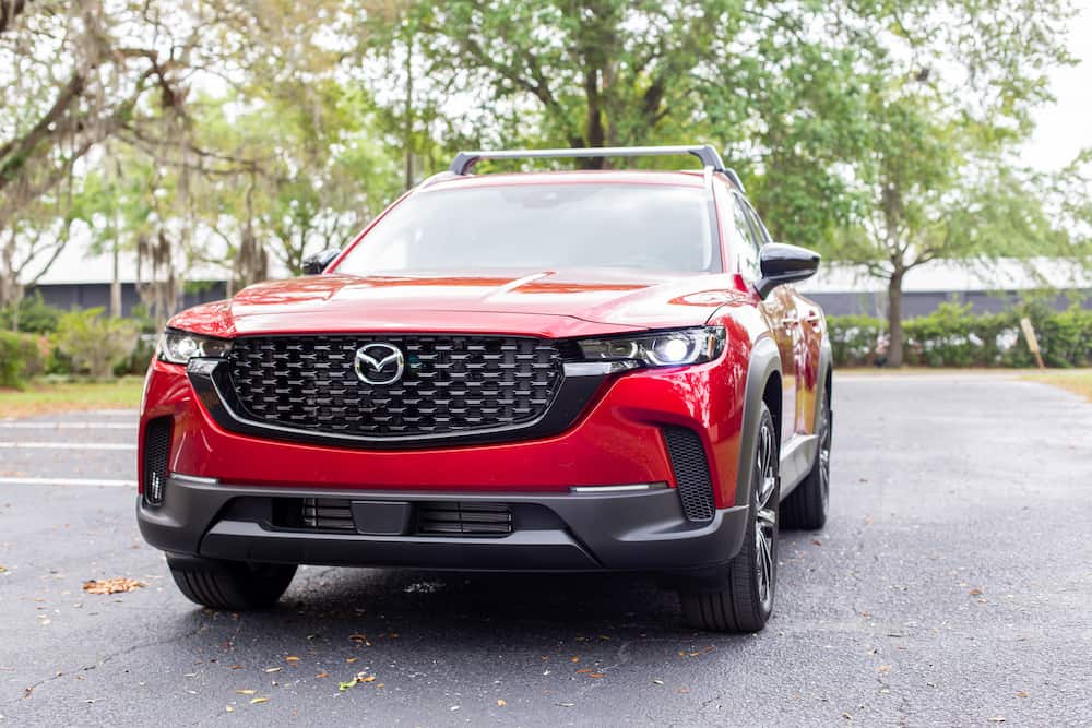Front three-quarter view of a Soul Red Crystal Metallic Mazda CX-50