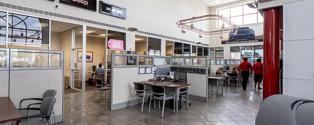 Interior view of AutoNation Chrysler Dodge Jeep Ram Spring finance center desks with partitions