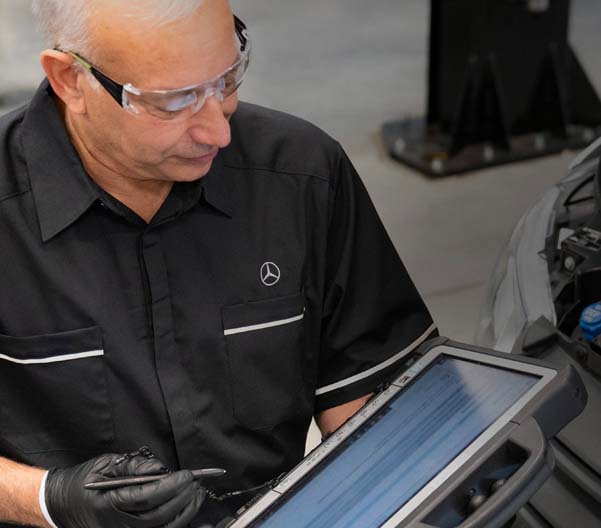 Mercedes-Benz service worker working on a Sprinter Van.