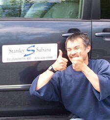 George giving thumbs up in front of the courtesy vehicle