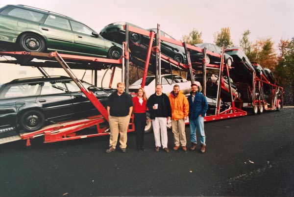 Geddy and the crew, including Dick Stanley and Mark Politte in front of a load of (then) new cars