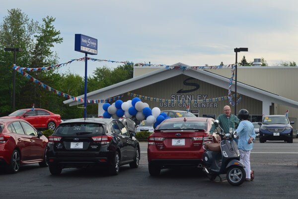 Grand Executive Director Nick Turner and scooter raffle winner Phyllis Young talk with the remodeled annex in the background
