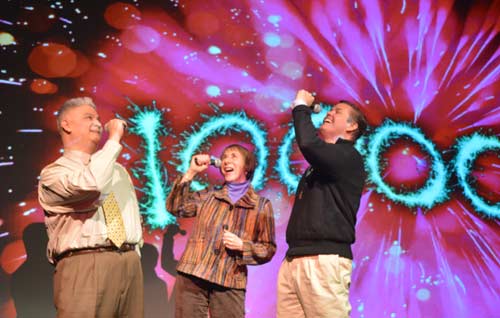 Bill, Gail, and Mark hold mics to sing in anticipation of the Grand Mouth Off Lip Sync Battle