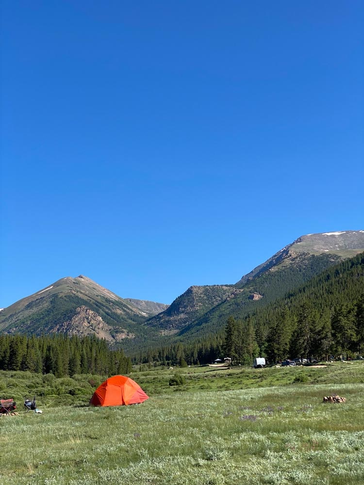 campsite on a glen with a mountainous background