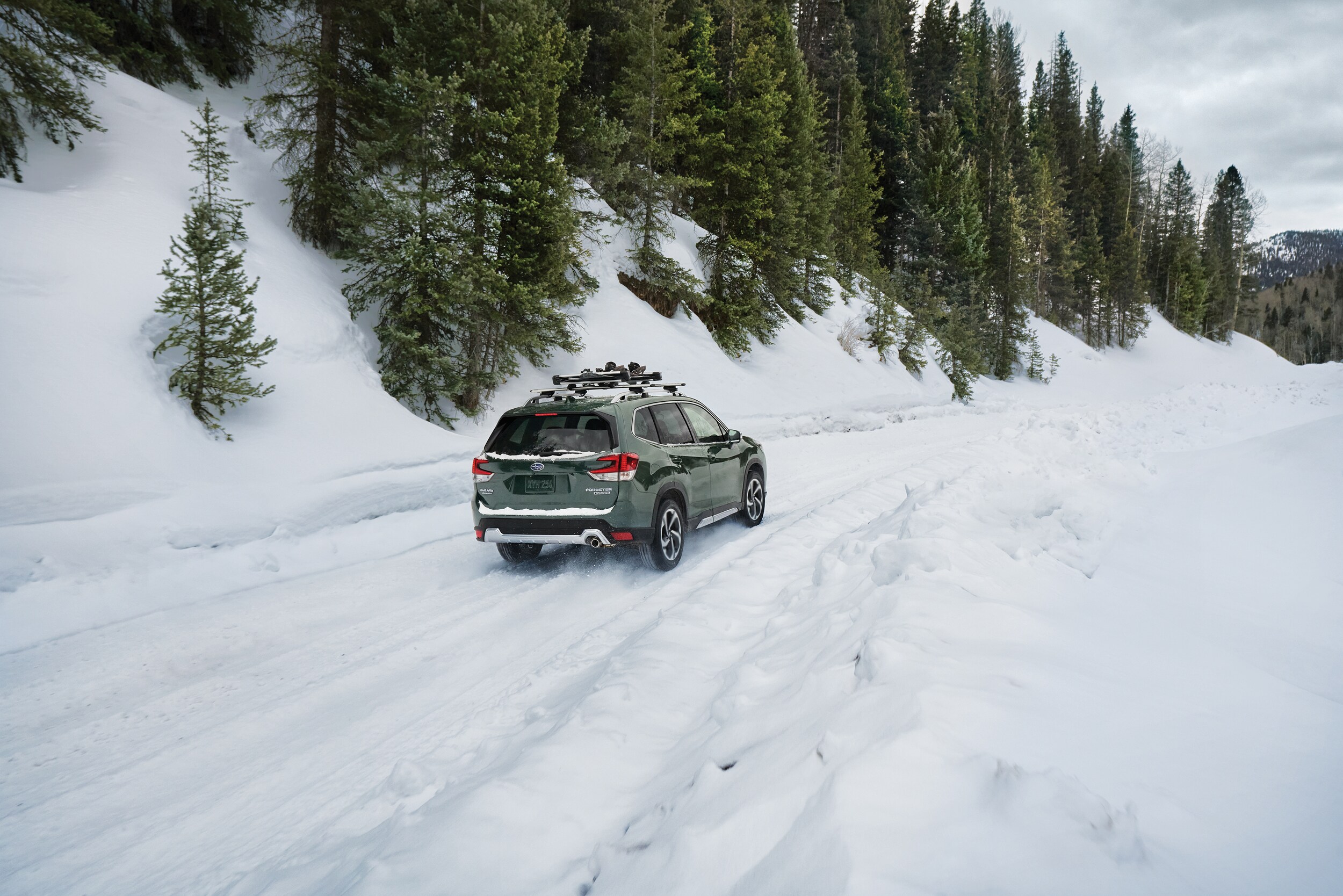  Green Subaru Forester Touring driving in snow