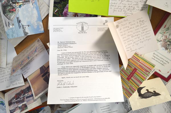 A letter from Down East Hospice Volunteers surrounded by the other notes on our thank you board
