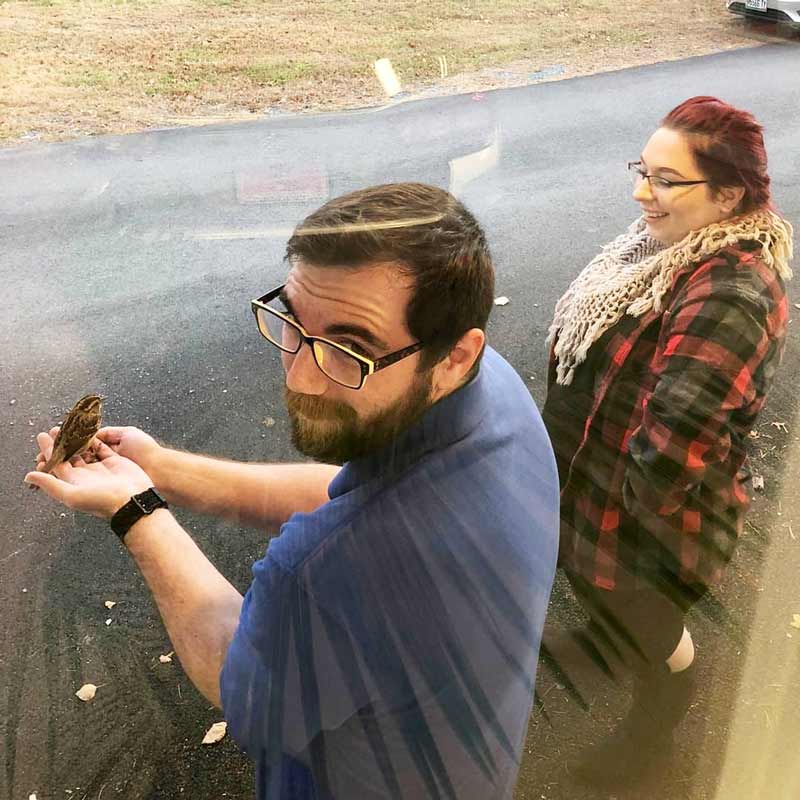 Spencer and Katie with the sparrow making sure it's okay