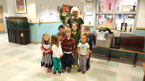 A Brooklin School teacher and her small charges accepting a Teacher Appreciation flower arrangement