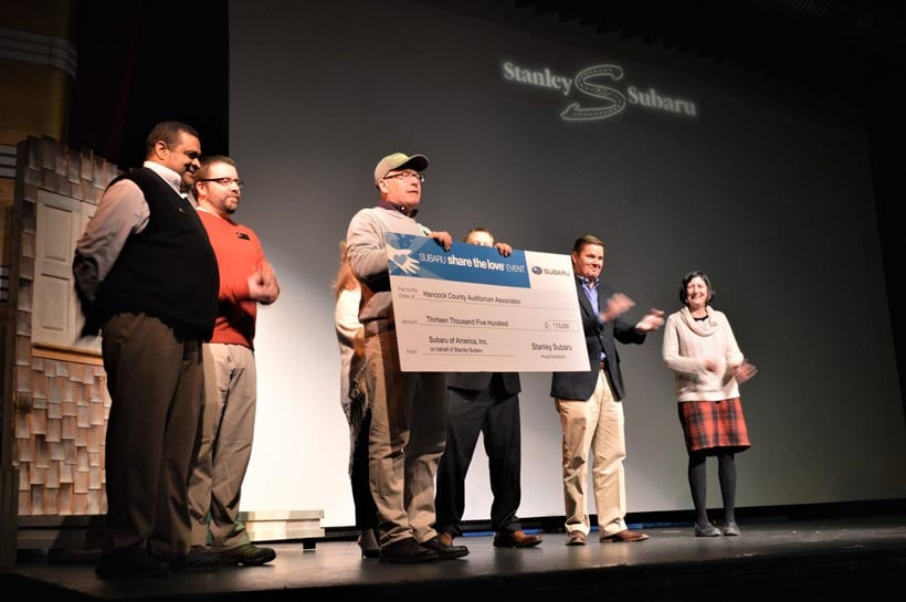 Check announcement on stage at The Grand on opening night of Wizard of Oz