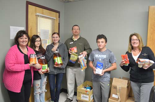Educators, students, and Stanley Subaru staff pose with donated food from the food drive at Trenton Elementary School