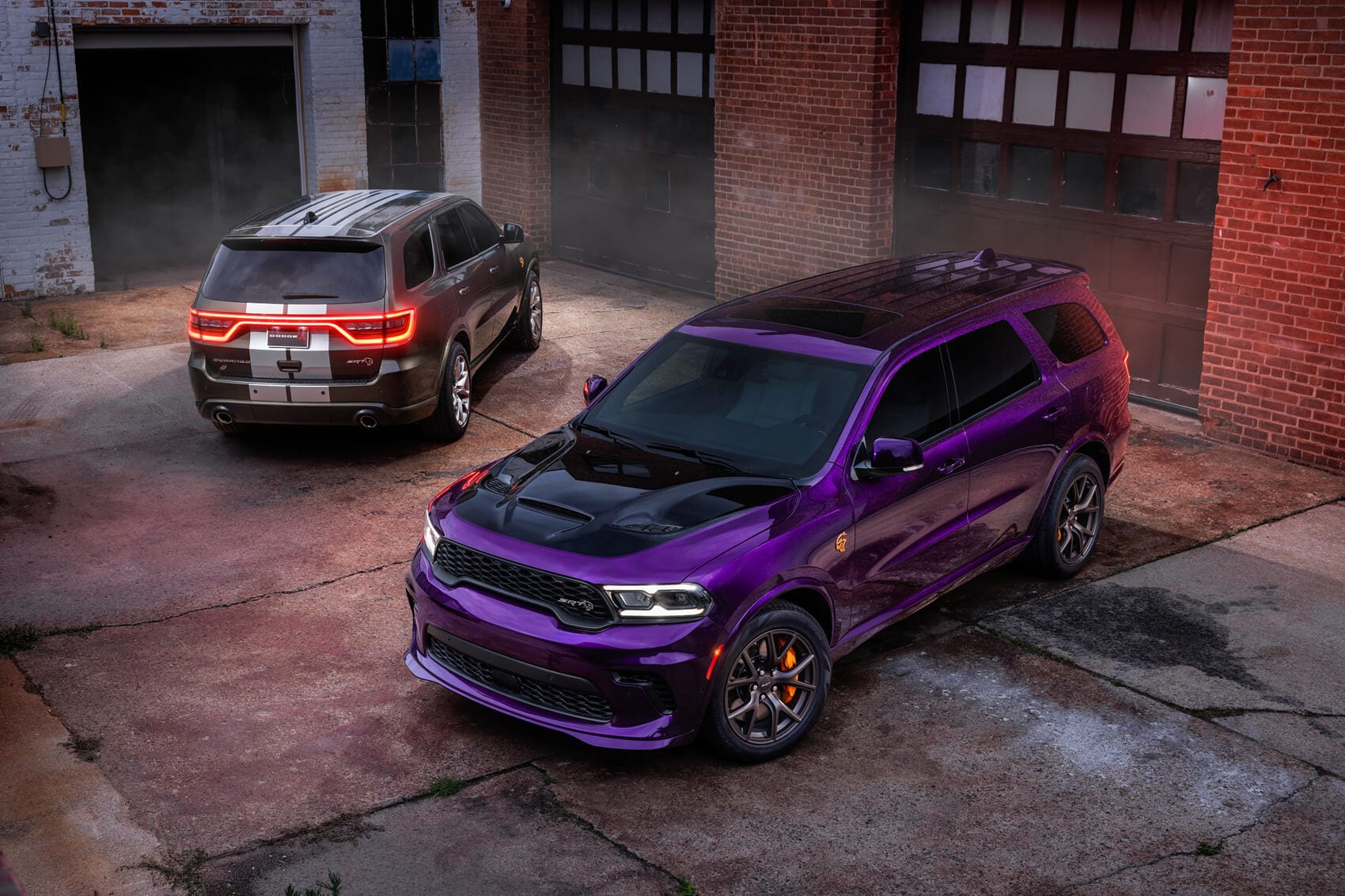 Purple and red dodge durango in front of building