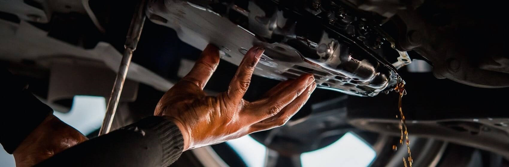 Mechanic working with transmission oil