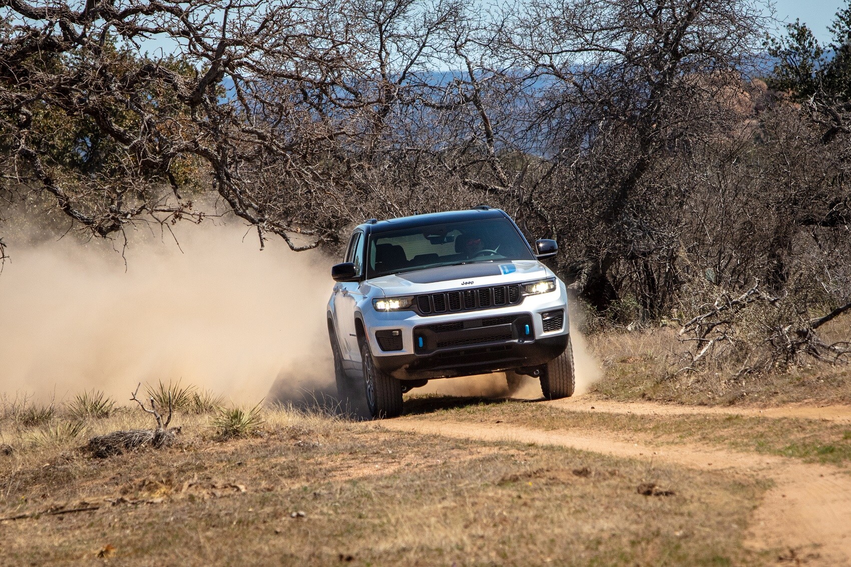 Jeep Cherokee driving through dirt trail