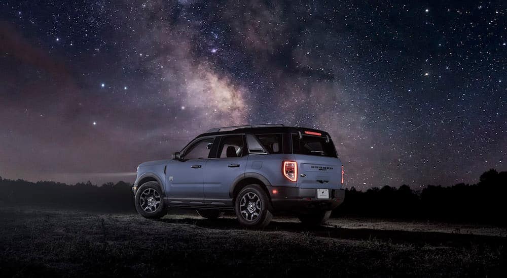 A blue 2024 Ford Bronco Sport is shown from the rear at an angle.
