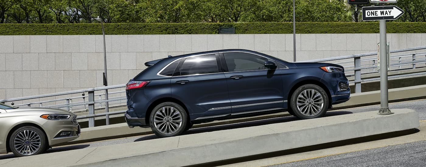 Side view of a blue 2022 Ford Edge parked on a city street.