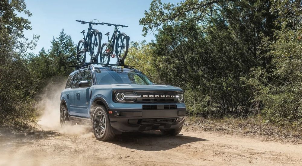 A blue  2024 Ford Bronco Sport Outer Banks is shown kicking up dust after leaving a Ford dealer near Brownsville.