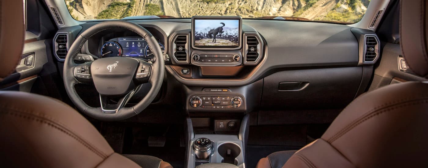 The brown interior of a 2024 Ford Bronco Sport is shown from between the seats.