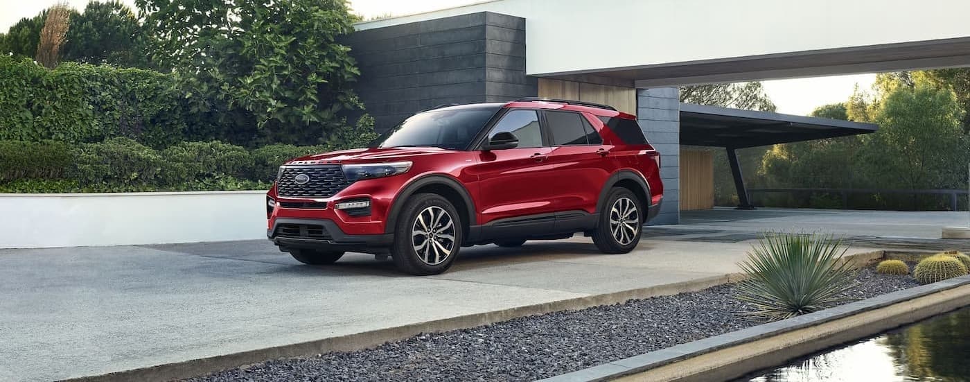 A red 2023 Ford Explorer parked near a used car dealer near Medina.