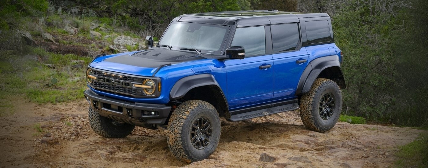 A black 2025 Ford Bronco Raptor is parked off-road.