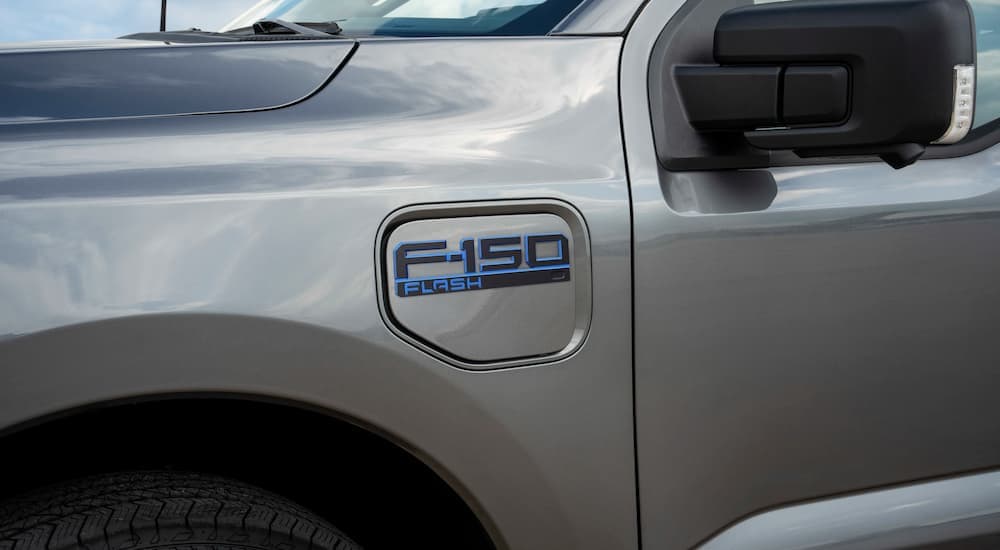 A close up of the blue 2024 Ford F-150 Lightning Flash badge.