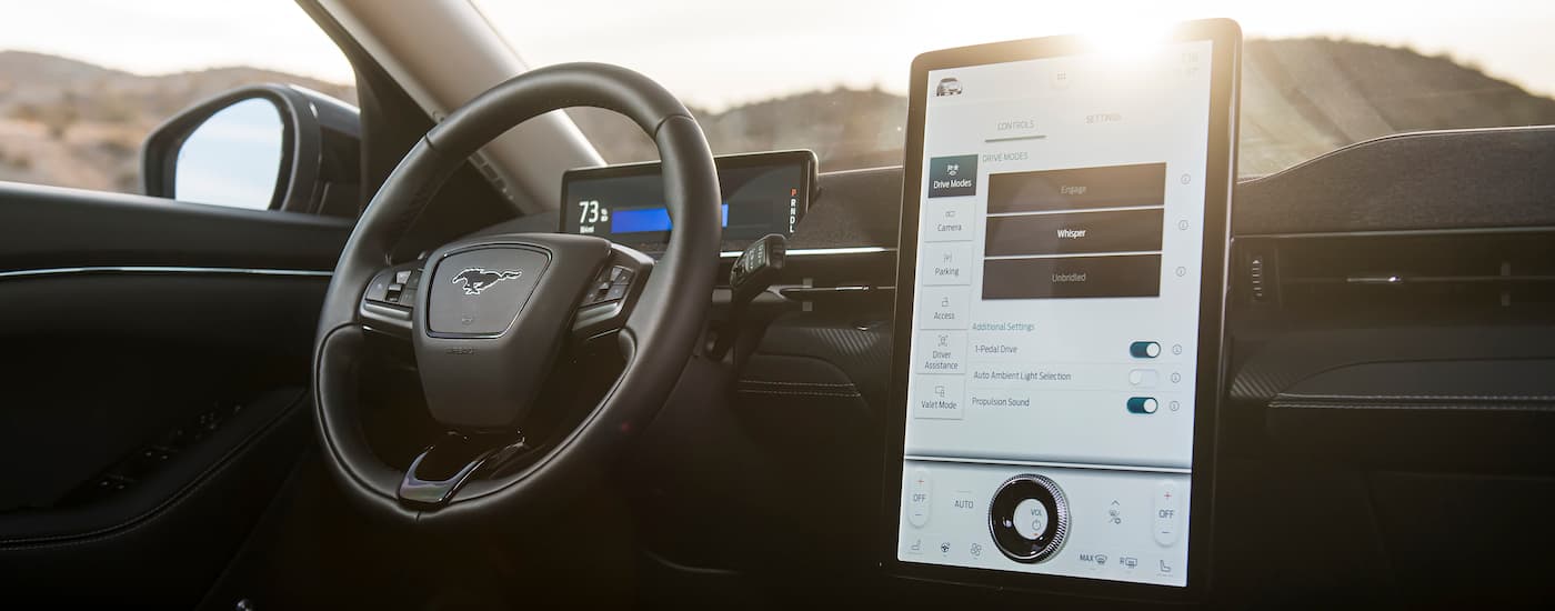 The interior of a 2024 Mustang Mach-E is shown from the passenger side.