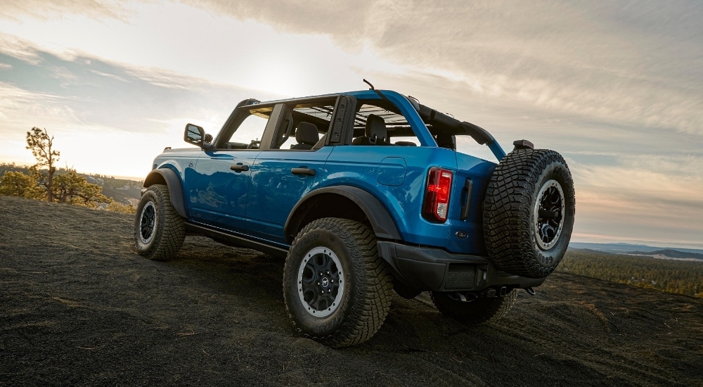 A blue 2025 Ford Bronco is shown from the rear at an angle.