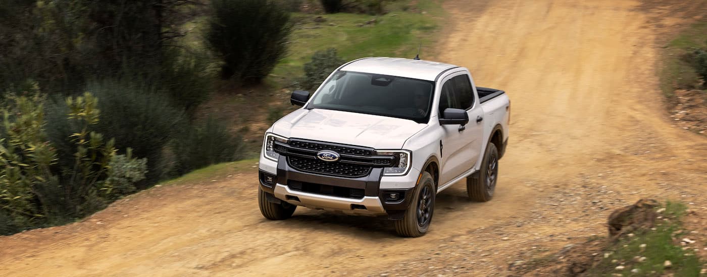 A white 2024 Ford Ranger XLT is shown from the front at an angle after leaving a Ford dealer near Medina.