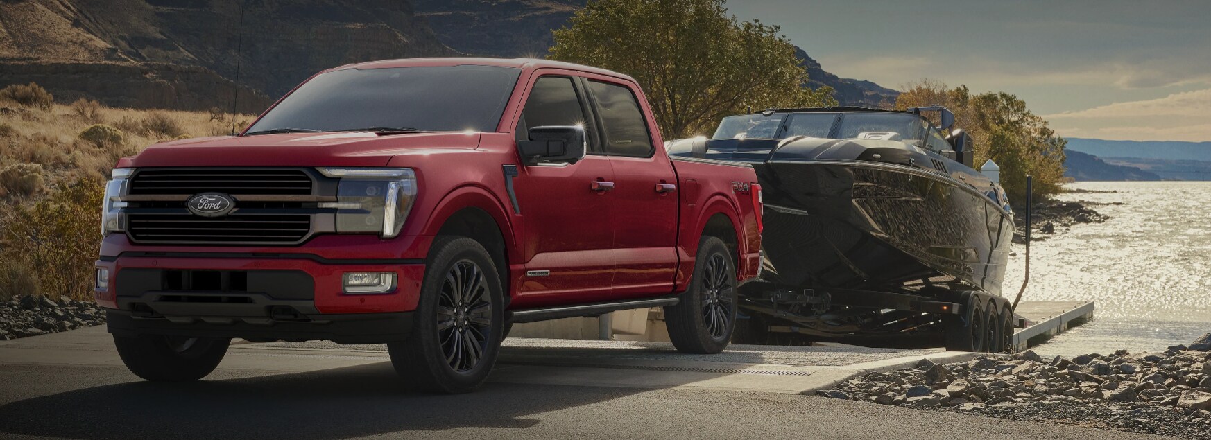 Two people exiting a 2025 Ford F-150® XLT pickup in Rapid Red hitched to a trailer of ATVs