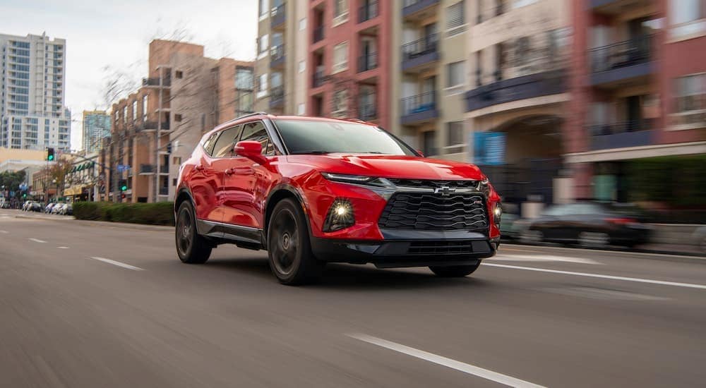 A red 2019 Chevy Blazer RS is shown driving after visiting a used car dealer.